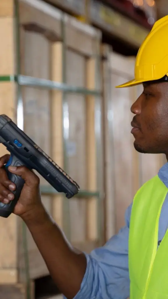 Man is using a bar code reader in a warehouse