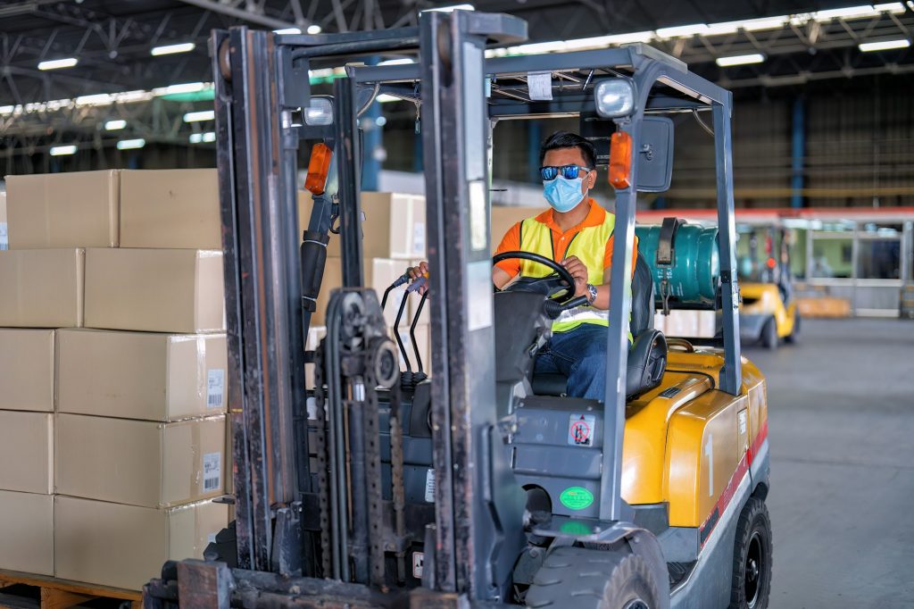 Forklift truck working in the big warehouse